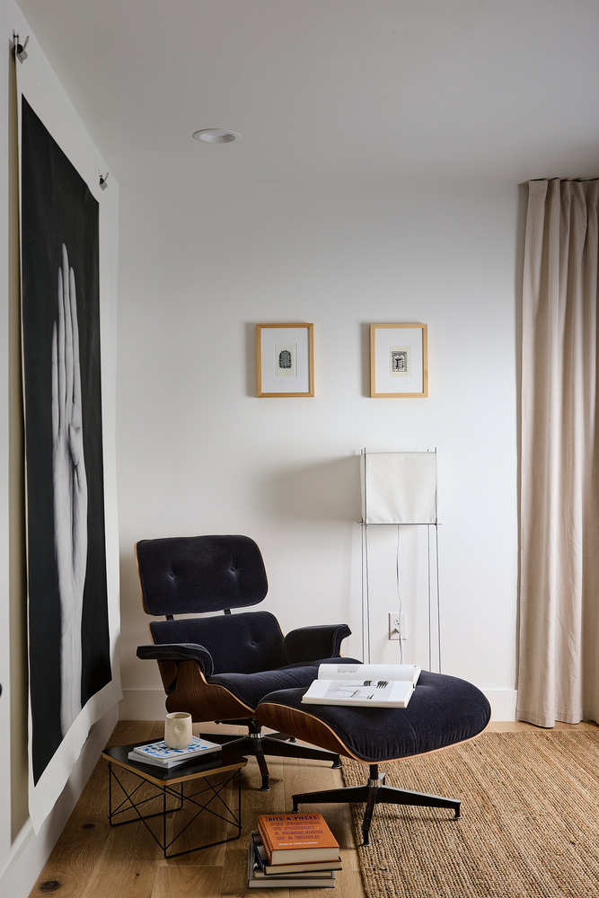 modern lounge corner with Eames chair and artwork by RedOven Builds in Lockhart, TX
