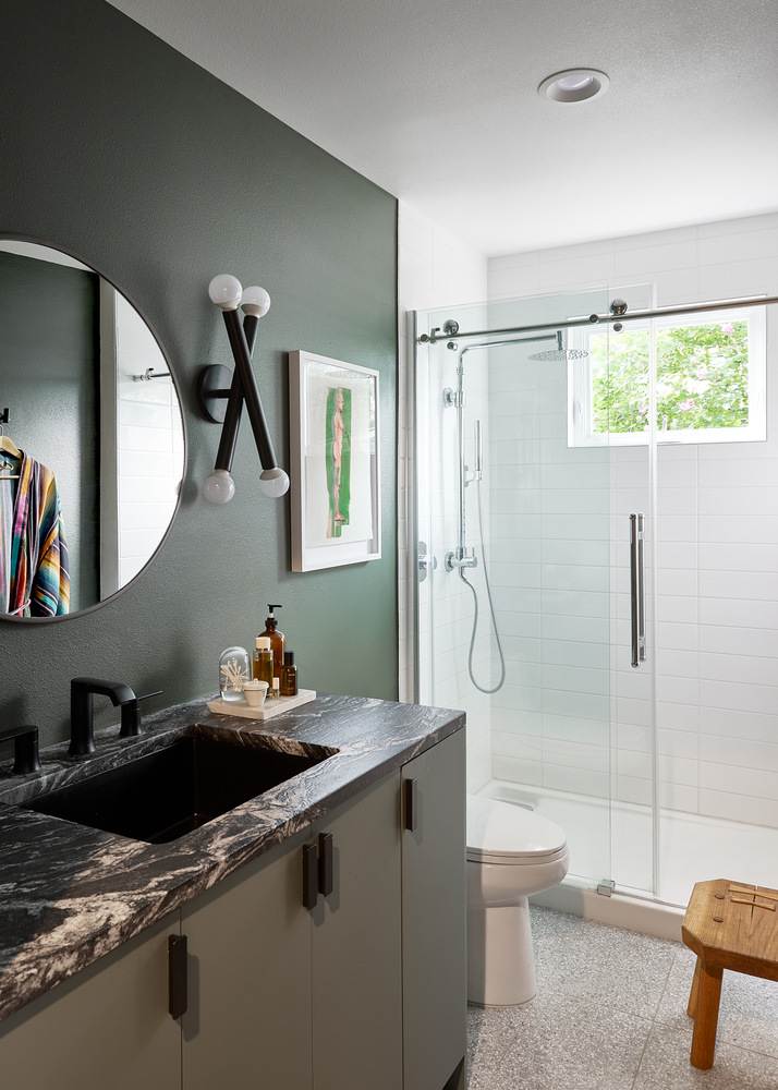 stylish gut remodel bathroom featuring marble countertop and frameless shower by RedOven Builds in Lockhart, TX