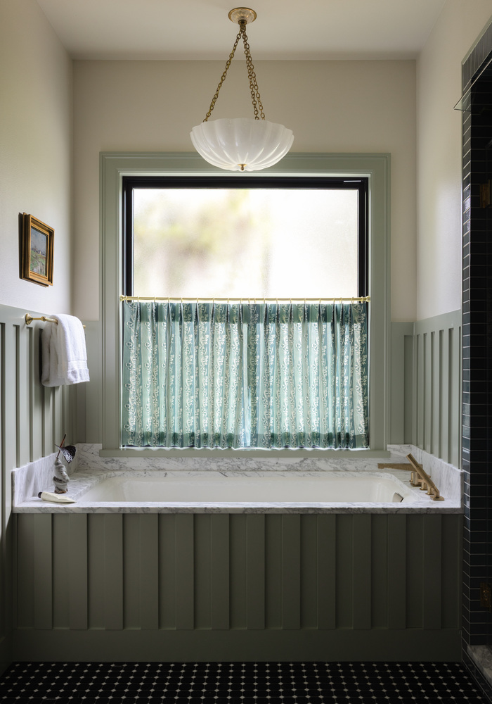 Bathroom tub remodel by RedOven Builds in West Rim Dr Austin TX with marble surround and window treatment