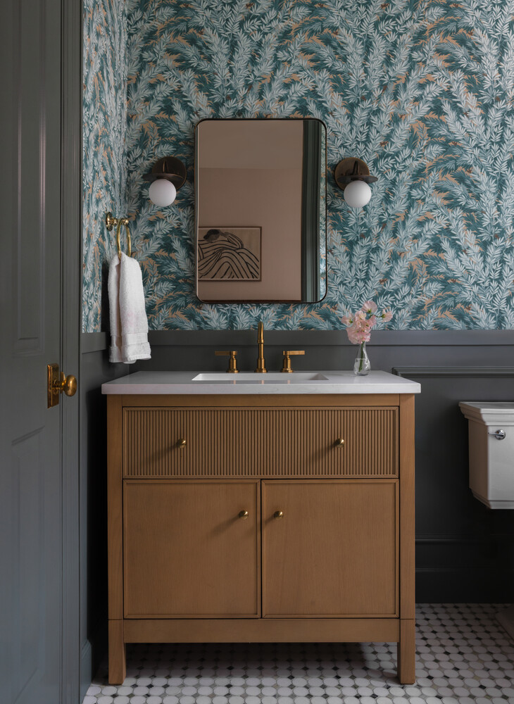 Bathroom vanity remodel by RedOven Builds in West Rim Dr Austin TX with patterned wallpaper and wood cabinet