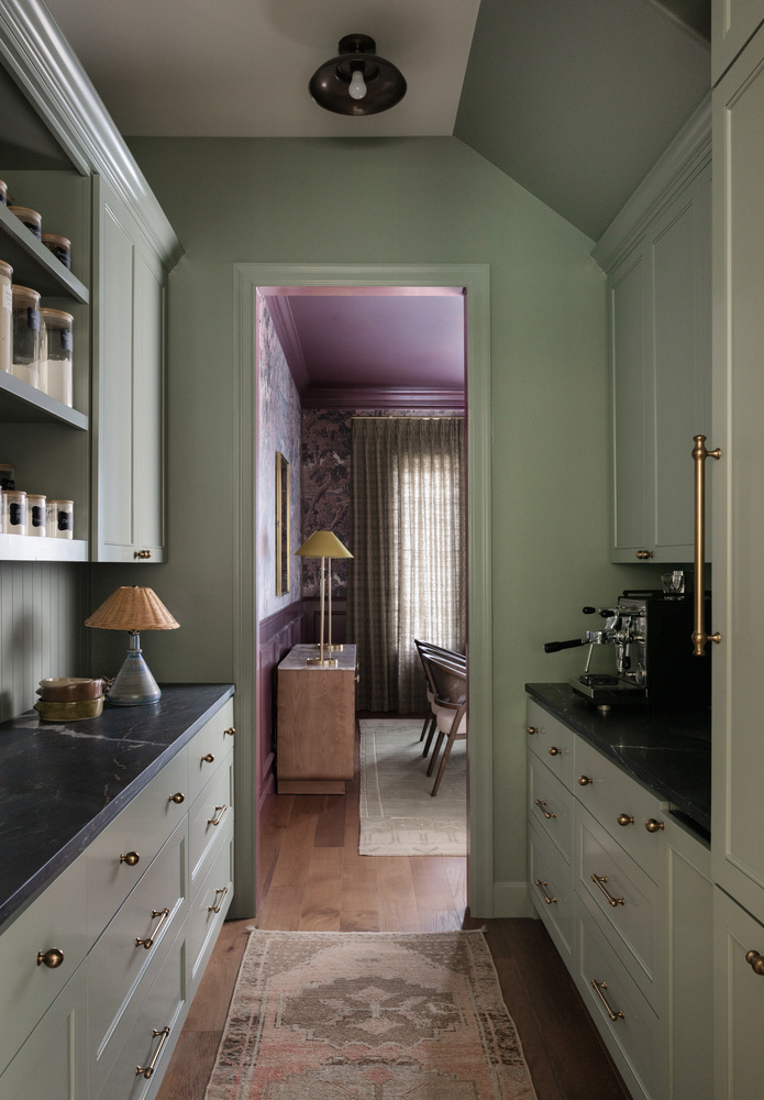 Butler’s pantry remodel by RedOven Builds in West Rim Dr Austin TX with green cabinetry and dark countertops