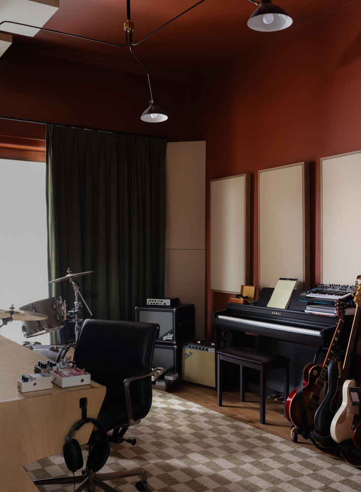 Home music room remodel by RedOven Builds in West Rim Dr Austin TX with piano, guitars, and acoustic panels