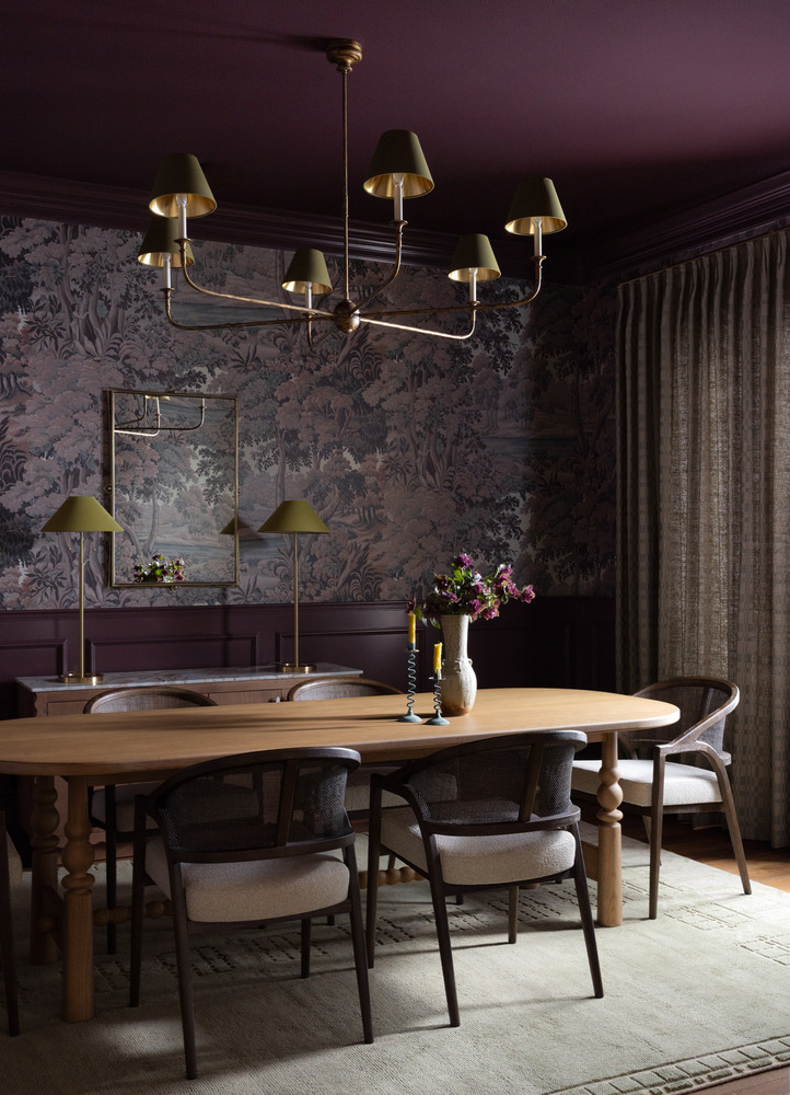 Moody dining room remodel by RedOven Builds in West Rim Dr Austin TX featuring floral wallpaper, wood table, and brass chandelier