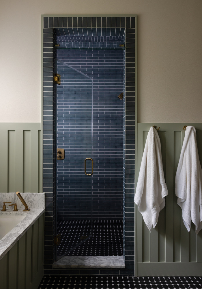 Walk-in shower remodel by RedOven Builds in West Rim Dr Austin TX with blue tile and glass enclosure