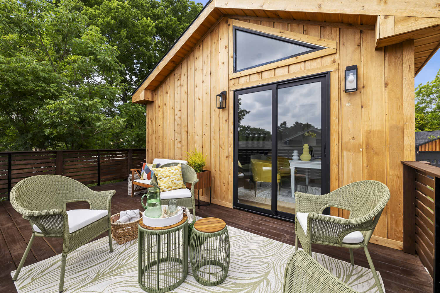 Exterior deck addition in Austin TX by RedOven Builds featuring wood siding and patio furniture