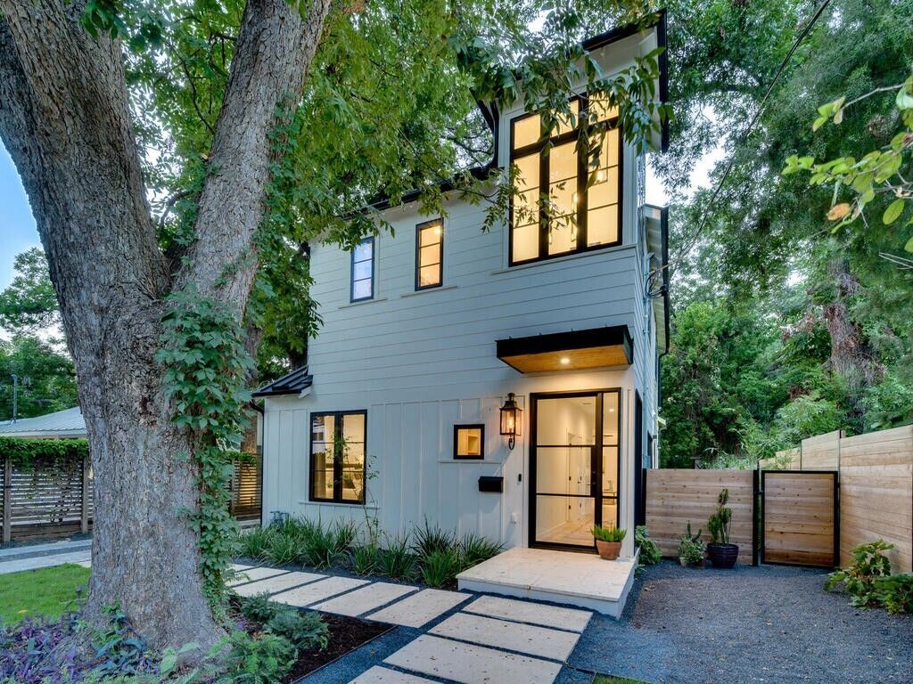 contemporary two-story custom home exterior with black framed windows in Austin TX by RedOven Builds