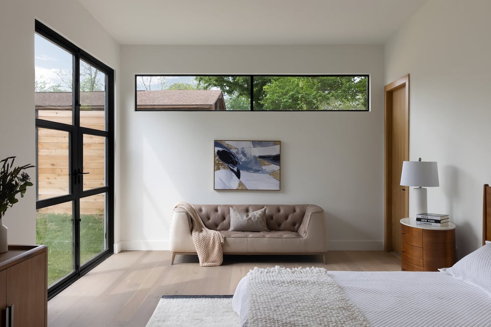 minimalist bedroom design with natural light and wood accents in Austin TX custom home by RedOven Builds