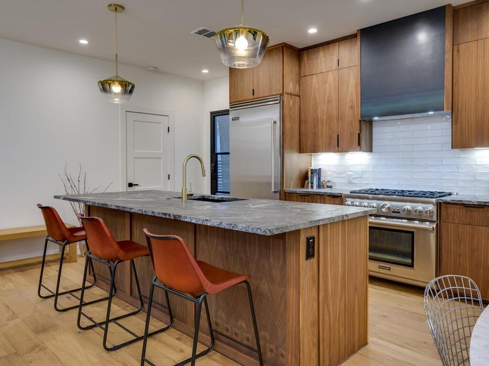 stylish kitchen with wood finishes and modern appliances in Austin TX kitchen remodeling by RedOven Builds