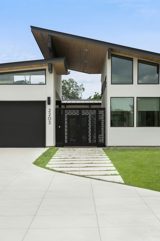 close up of modern custom home front gate and walkway by RedOven Builds in San Juan Dr Rio Grande TX