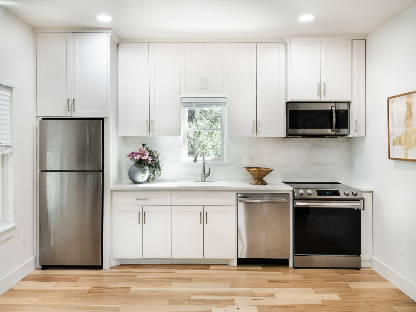 Bright kitchen remodel addition in Austin by RedOven Builds featuring modern cabinetry and finishes